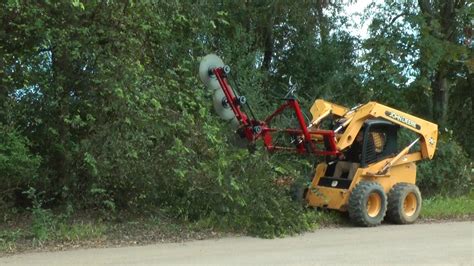 tree trimmer for skid steer m & m manufacturing|skid steer tree trimming attachment.